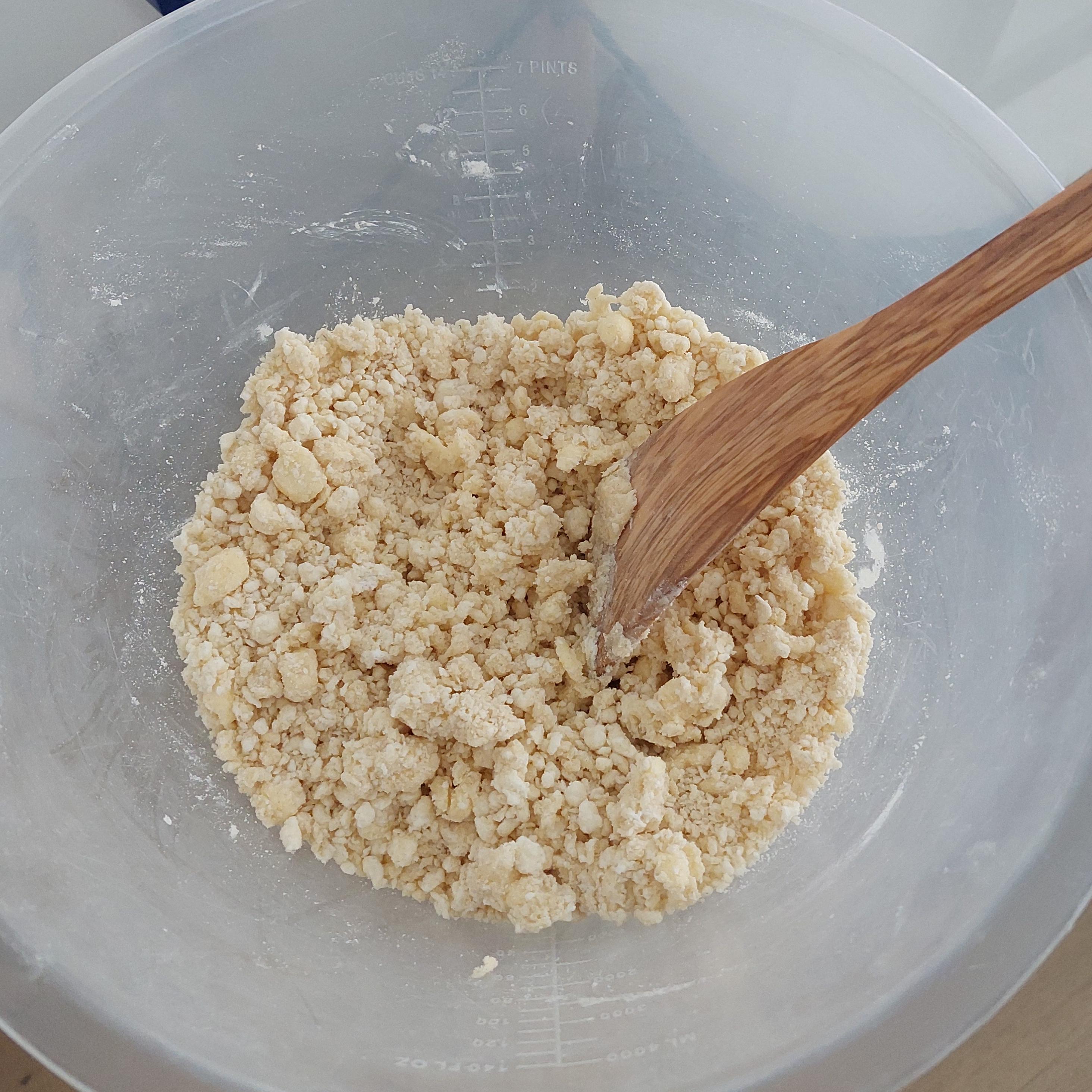 With a knife or wooden spatula, cut butter and curd cheese incorporating them into flour (5-7 mins). Until there are no large chunks of butter or curd cheese.