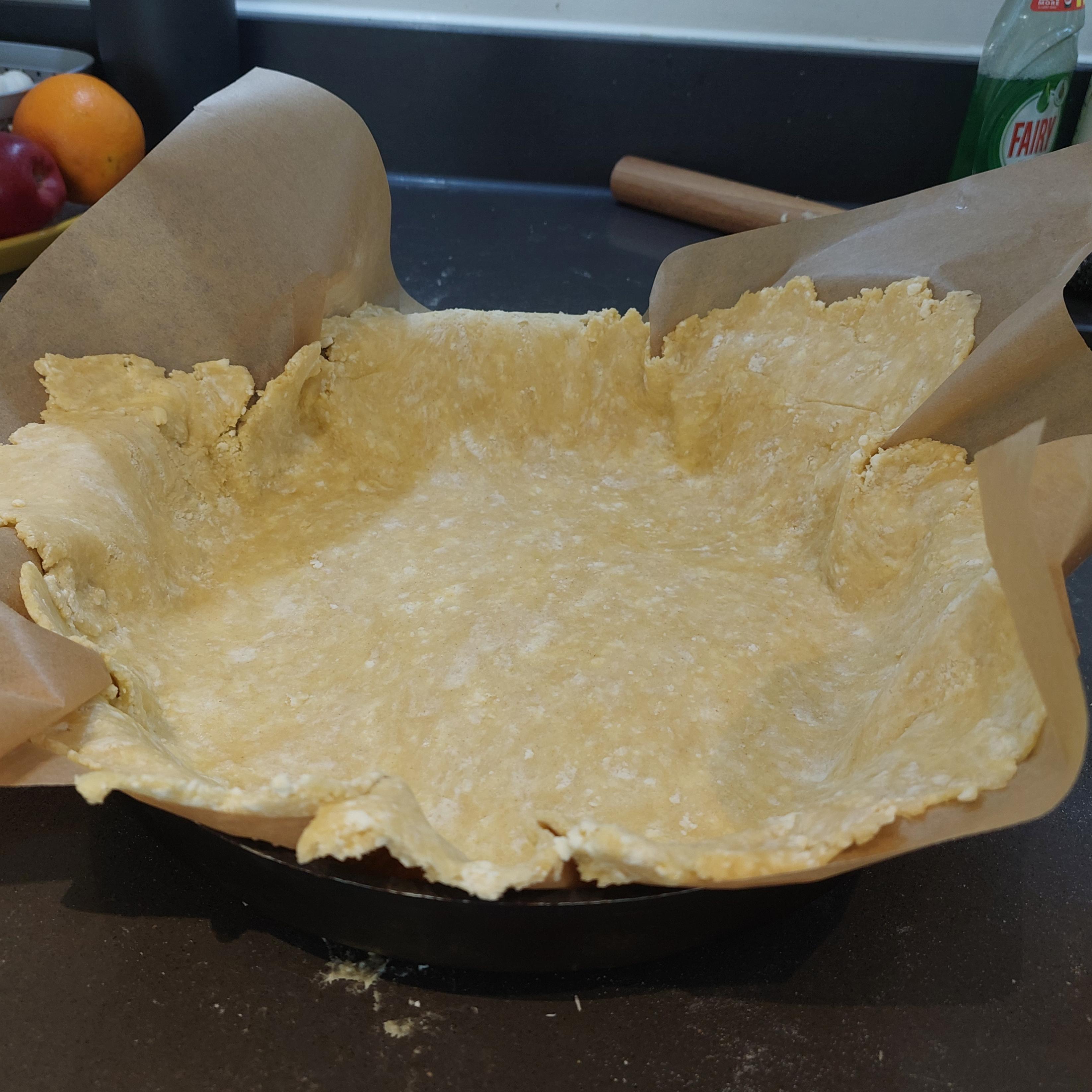 Transfer the dough on baking paper to the pan, then gently press to fit the shape.